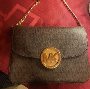 Michael Kors crossbody bag with gold hardware.